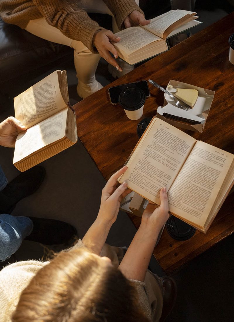 high-angle-people-reading-together